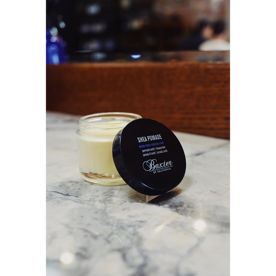 Baxter of California Shea Pomade. Delivers a medium hold with a natural look, enriched with shea butter for a smooth, moisturized finish. Great for versatile and manageable styles. 2 fl oz.