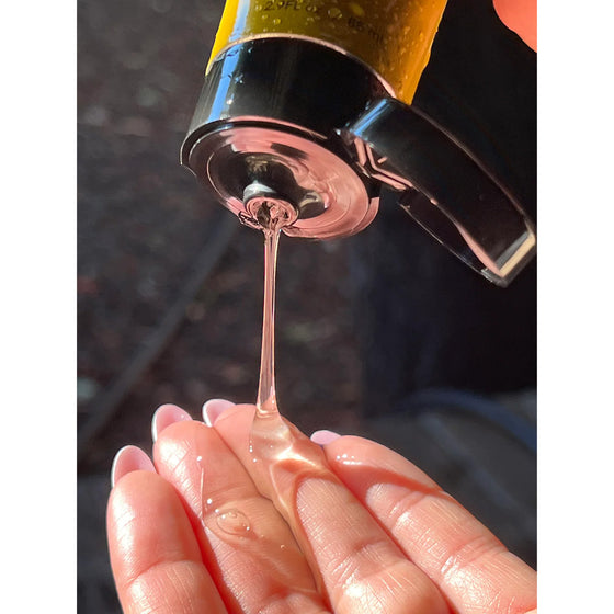 KOA Yuzu Facial Cleanser. Being poured onto hand. Invigorating gel cleanser with Yuzu and Green Tea, designed to refresh, balance, and cleanse skin while preserving natural moisture.