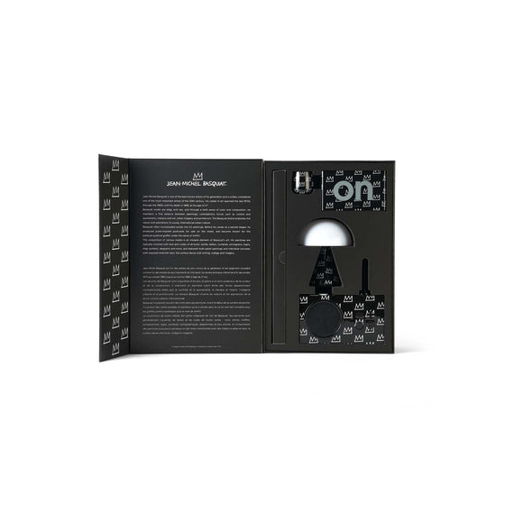 Interior view of the Lexon x Jean-Michel Basquiat Crown Black set, showing art-branded speaker and accessories placed in custom-fitted packaging.