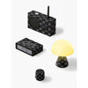 Full display of Crown Black gift set contents arranged flat, celebrating Basquiat’s crown motif across compact tech objects in a unified, premium presentation.