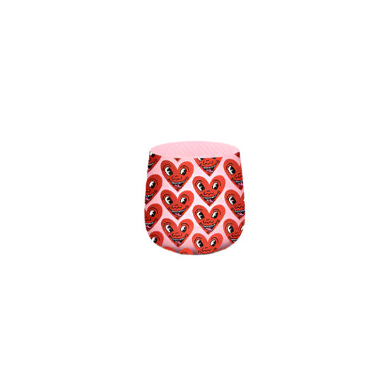 Compact pink Lexon MINO+ Bluetooth speaker featuring Keith Haring’s iconic heart artwork. Portable with built-in mic, selfie remote, and TWS pairing—designed for art lovers.
