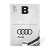 Magazine B - Issue 23 Audi. A close-up of an Audi emblem on a car, highlighting the intricate details and craftsmanship.