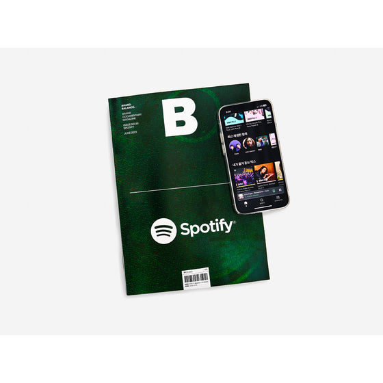 Magazine B - Issue 95 Spotify The magazine is displayed on a white background next to a phone with the Spotify app open, highlighting the brand’s digital presence and streaming service.