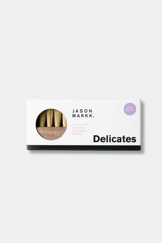 Jason Markk Premium Cleaning Brush. Brush displayed in its packaging, showing the product and key features like the handcrafted walnut handle and soft hog bristles.