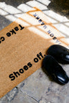 Jason Markk Shoes Off Welcome Mat. Mat placed at the entrance of a home with shoes on it, demonstrating its use in keeping indoor spaces clean.